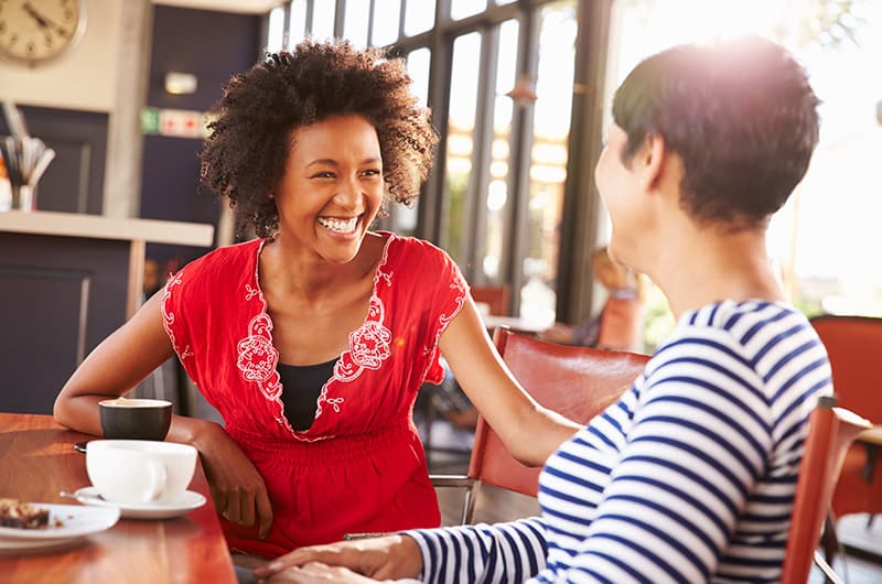 Smiling woman having coffee